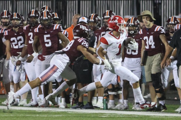 Marist's Gavin O'Brochta (1) gets yards after the catch against Brother Rice during a CCL/ESCC crossover game in Chicago on Friday, Sept. 6, 2024. (Troy Stolt / Daily Southtown)