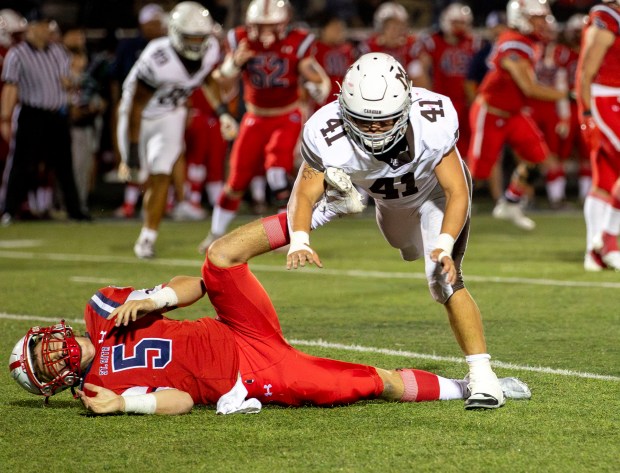 Mount Carmel's Matt Mucha (41) tackles St. Rita's Steven Armbruster (5) during a game at St. Rita High School in Chicago on Friday, Sept. 6, 2024. (Nate Swanson / Daily Southtown)