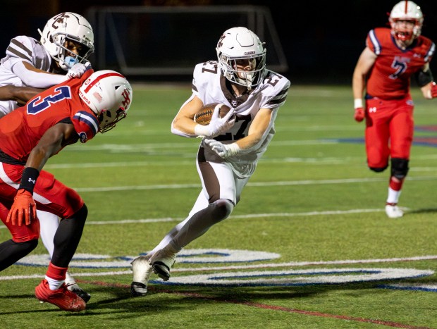 Mount Carmel's Zander Gorman (27) runs the ball in the fourth quarter during a game at St. Rita High School in Chicago on Friday, Sept. 6, 2024. (Nate Swanson / Daily Southtown)