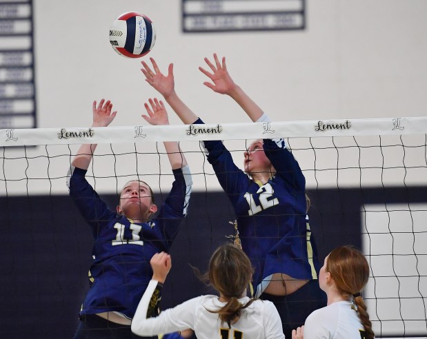 Lemont's Izabella Kowalczyk (12) and Sophia Swiderski go up for the ball during a game agains Richards on Thursday, Sept. 5, 2024 in Lemont...(Jon Cunningham for the Daily Southtown)