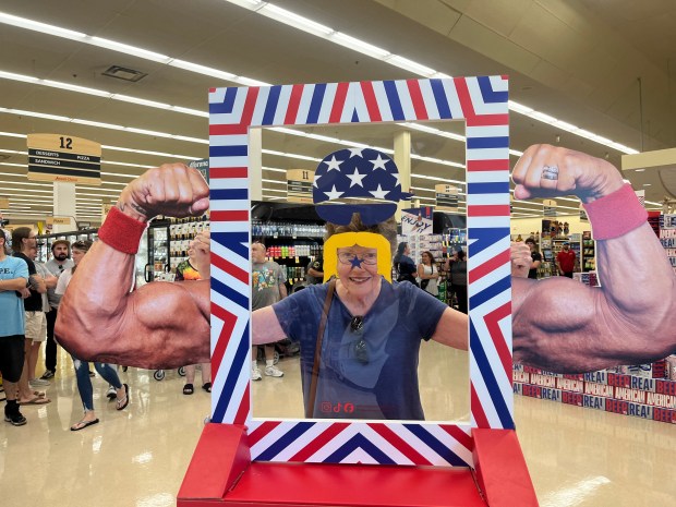 Cathy Hartney, 81, of New Lenox, has fun posing Sept. 18, 2024, during Hulk Hogan's appearance at Jewel in New Lenox. (Jeff Vorva/for the Daily Southtown)