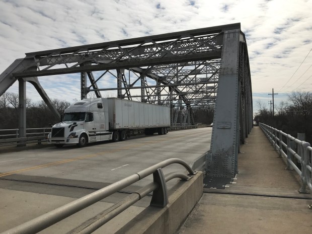 A truck rumbles across the Crawford Avenue bridge over the Cal-Sag Channel near the Alsip/Robbins border on Feb. 25, 2019. The bridge has been identified as a "unique Parker-style truss bridge and is eligible for listing on the National Register of Historic Places," according to a Cook County overview of a planned project along Pulaski Road. (Ted Slowik/Daily Southtown)