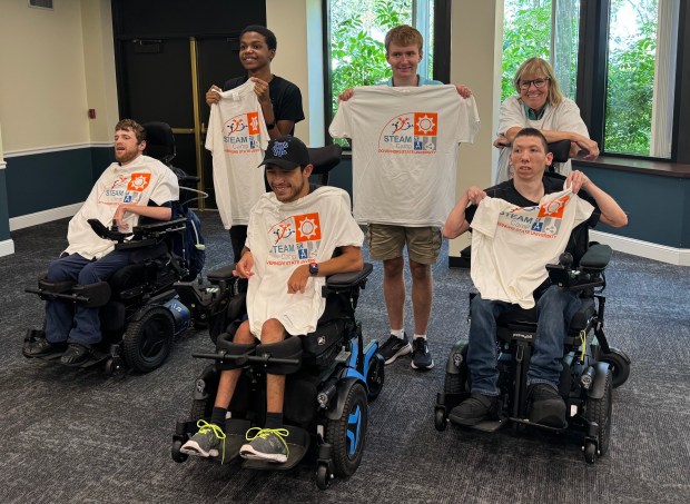 Robbie O'Shea, far right, a retired Governors State University faculty member and co-leader of the Jaguar Jumps program, stands with students showing off T-shirts they received as part of the one-day Jaguar Jumps STEAM session in July. Jaguar Jumpers are Anthony Beese, left, Julian Johnson, Elijah Gomez, Patrick Gannon and Trenton Jankuski. (Michelle Sebasco)