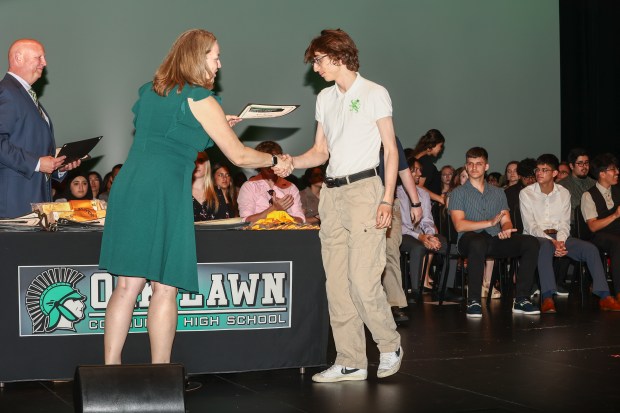 Jeana Naujokas, Oak Lawn High School principal last year and now assistant superintendent for personnel and human resources, awards the first Charles Yara scholarship to graduating senior Neo Martin. (Oak Lawn High School)