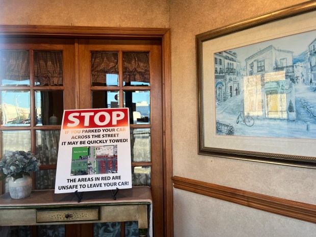 A sign in the vestibule at Palermo's on 95th warns customers who may have parked in another lot. (Brett Johnson/Daily Southtown)