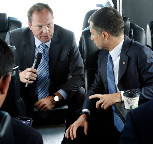 U.S. Transportation Secretary Pete Buttigieg (right) listens to Daniel Vicari, Executive Director of the Gary/Chicago International Airport (left) during a bus tour of the Gary/Chicago International Airport to view projects that are creating jobs and improving the airport's cargo operations on Wednesday, August 30, 2023. (John Smierciak / Post Tribune)