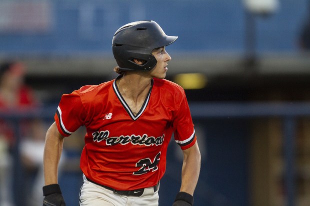 Lincoln-Way West's Tyler Koscinski looks at the ball he hit June 29, 2022, while running to first base against Lane Tech during the Phil Lawler Summer Classic championship game at Curtis Granderson Stadium in Chicago. (Vincent D. Johnson / Daily Southtown)