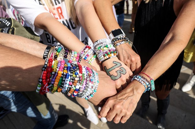 Fans display friendship bracelets as they wait to enter Soldier Field for Taylor Swift's Eras Tour on June 2, 2023, in Chicago.