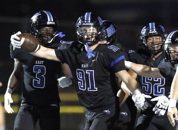 Lincoln-Way East's Caden O'Rourke (91) celebrates with teammates after returning an interception for a touchdown against Batavia during a nonconference game in Frankfort on Friday, Sept. 2, 2022.