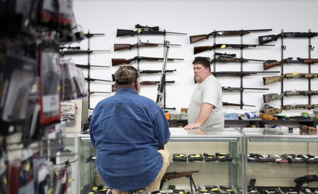 Mark Sackrider of Sacky's Firearm Sales talks with a customer on Jan. 26, 2023, in Jasper County, Illinois. Sackrider said at the time, that about one-half of the guns at his shop could not be sold to customers because of the state firearms legislation. (John J. Kim/Chicago Tribune)