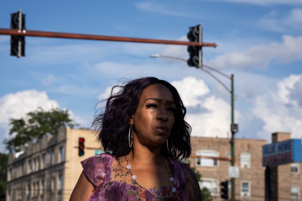 Brandy Martin stands at the gas station at Western Avenue and Marquette Road where her 15-year-old nephew, Sincere Cole, was shot more than 20 times in 2022 - just 300 feet from a POD camera that sits to the right, in the distance. (E. Jason Wambsgans/Chicago Tribune)