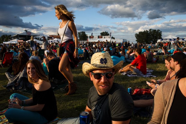 Wearing a Notre Dame cowboy hat, Mike Fletcher, 29, sits on the grass while attending the Windy City LakeShake country music festival at Northerly Island on June 25, 2017. (Armando L. Sanchez/Chicago Tribune)