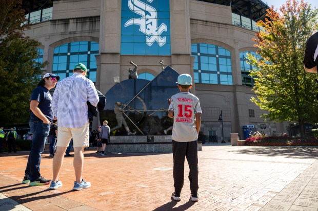 People stand outside Guaranteed Rate Field before a game against the Los Angeles Angels in Chicago on Sept. 26, 2024. Sitting on a record-tying 120 losses, the Sox's next loss will make them the most losing team in modern MLB history. (Tess Crowley/Chicago Tribune)