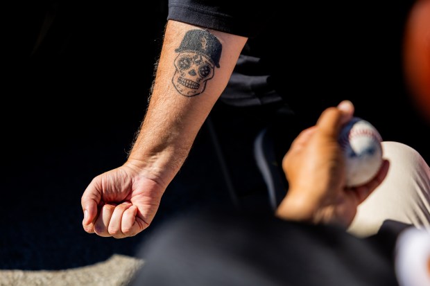 Anthony Gutierrez, from Arlington Heights, holds his arm out to show his White Sox tattoo at a tailgate outside the Guaranteed Rate Field before a game against the Los Angeles Angels in Chicago on Sept. 26, 2024. Sitting on a record-tying 120 losses, the Sox's next loss will make them the losingest team of the modern era. (Tess Crowley/Chicago Tribune)