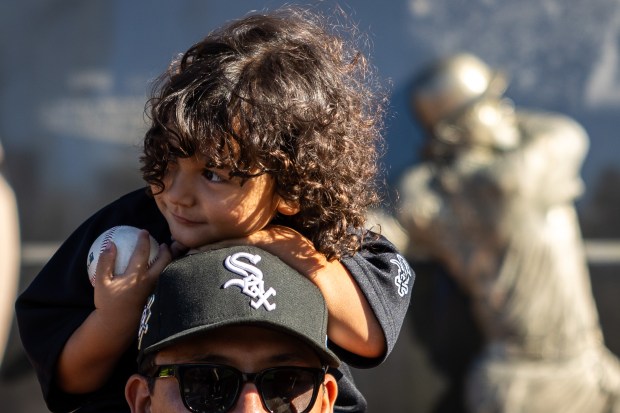 Inri Munoz, 2, smiles on her father's Julio Munoz, shoulders outside Guaranteed Rate Field after the White Sox won 7-0 against the Los Angeles Angels in Chicago on Sept. 26, 2024. Despite their record-tying 120 losses this season, the Sox won 7-0 against the Angels. (Tess Crowley/Chicago Tribune)