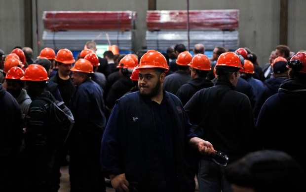 Workers wait for the arrival of former President Bill Clinton for a campaign stop with Gov. Pat Quinn and Sen. Dick Durbin at Wheatland Tube in Chicago on Oct. 21, 2014. (Jose M. Osorio/Chicago Tribune)