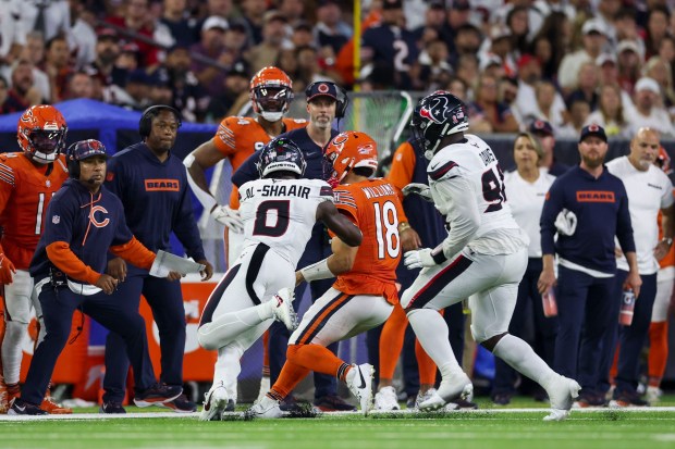 Houston Texans linebacker Azeez Al-Shaair (0) hits Chicago Bears quarterback Caleb Williams (18) out of bounds during the third quarter at NRG Stadium Sunday Sept. 15, 2024, in Houston. (Armando L. Sanchez/Chicago Tribune)