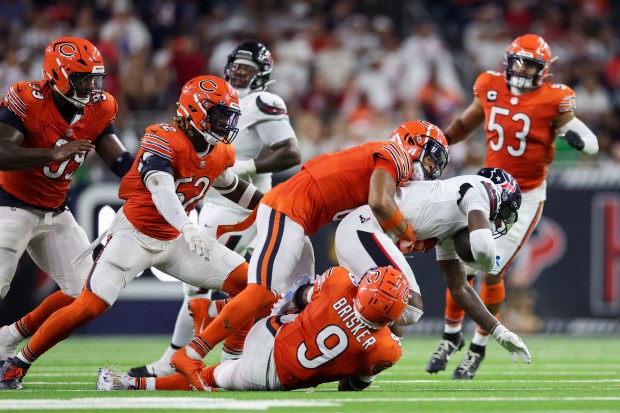 Chicago Bears cornerback Kyler Gordon (6) and Chicago Bears safety Jaquan Brisker (9) tackle Houston Texans wide receiver Stefon Diggs (1) during the fourth quarter at NRG Stadium Sunday Sept. 15, 2024, in Houston. (Armando L. Sanchez/Chicago Tribune)