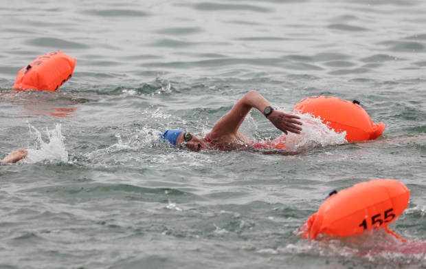 Mariel Hawley, of Mexico City, races alongside other competitors off Ohio Street Beach on Sunday, Sept. 22, 2024, as the inaugural Chicago River Swim is held in Lake Michigan. (Brian Cassella/Chicago Tribune)