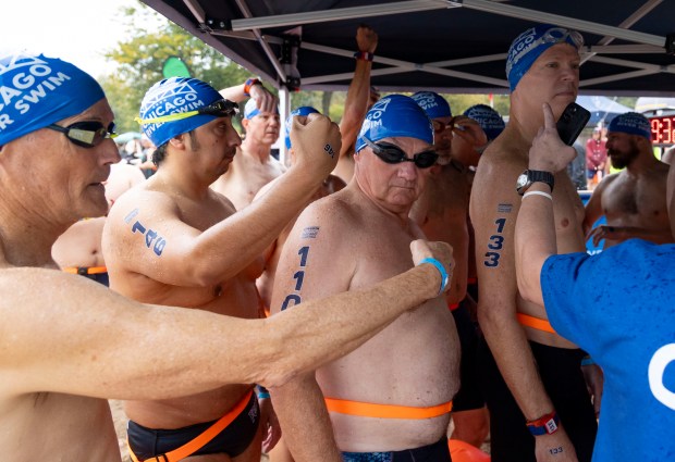 Swimmers prepare to wade into the water off Ohio Street Beach to begin the race Sunday, Sept. 22, 2024, as the inaugural Chicago River Swim is held in Lake Michigan. (Brian Cassella/Chicago Tribune)