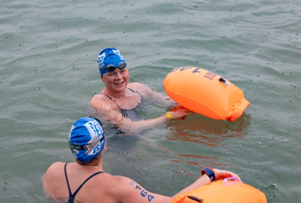 Becca Mann smiles after being the first swimmer to cross the finish line Sunday, Sept. 22, 2024, as the inaugural Chicago River Swim is held in Lake Michigan. (Brian Cassella/Chicago Tribune)