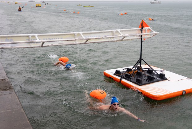 Swimmers cross the finish line on Sunday, Sept. 22, 2024. (Brian Cassella/Chicago Tribune)