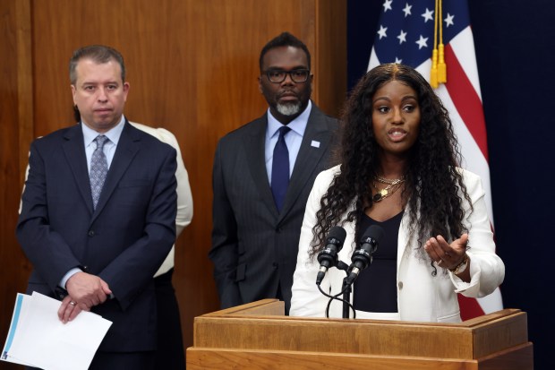 Chicago Public Schools CEO Pedro Martinez, left, Chicago Mayor Brandon Johnson and Chicago Teachers Union President Stacy Davis Gates hold a news conference at City Hall in Chicago on June 8, 2023. (Terrence Antonio James/Chicago Tribune)