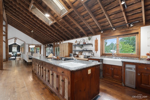 This former dairy barn at 51 Chippewa Drive in Oswego has six bedrooms, including two primary suites, as well as an elevator. (Creative Light Studios)