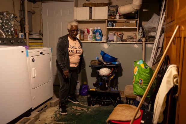 Shirley Howard looks at water seeping into her basement in the Austin neighborhood on Sept. 24, 2024. After major flooding from a 2023 storm, she had to replace a washing machine and some drywall. (Brian Cassella/Chicago Tribune)