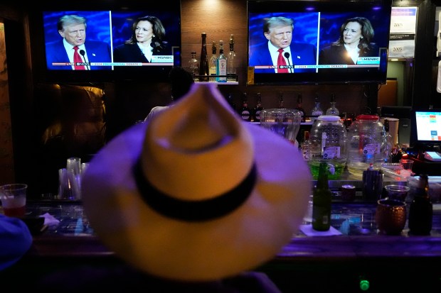 Charles Hudson, 76, from Chicago watches the presidential debate between Republican presidential nominee former President Donald Trump and Democratic presidential nominee Vice President Kamala Harris at the Knotty Luxe Bistro on Tuesday, Sept. 10, 2024, in Markham, Illinois. (Charles Rex Arbogast/AP)