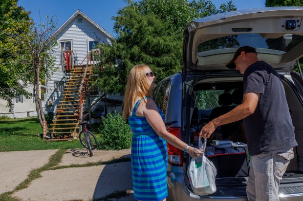 Matt Rowlee, right, an outreach specialist with the Perfectly Flawed Foundation, delivers harm reduction and overdose prevention supplies to Abby Hampton on Sept. 4, 2024, in Amboy, Illinois. (Armando L. Sanchez/Chicago Tribune)