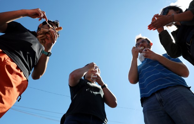 A group of friends eat Mexican ice cream at the Taste of Chicago Saturday, Sept. 7, 2024, in Chicago.(John J. Kim/Chicago Tribune)