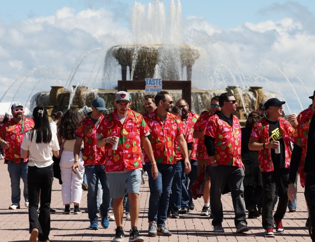 A group of men wearing matching shirts walk through the Taste of Chicago on Saturday, Sept. 7, 2024, in Chicago.(John J. Kim/Chicago Tribune)