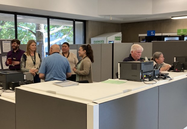 Election judges help voters on the first day of early voting. (Steve Sadin/For the Lake County News-Sun)