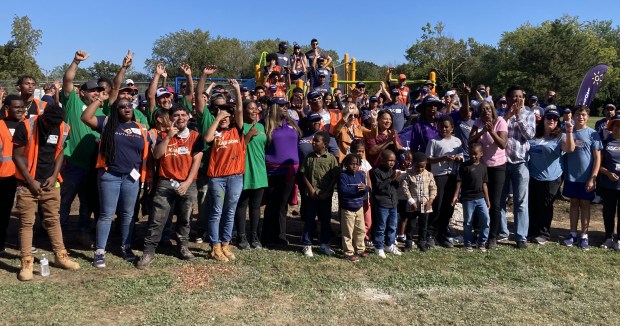 Volunteers, local officials and some of the children who helped design the new playground gather for a photo. (Steve Sadin/For the Lake County News-Sun)