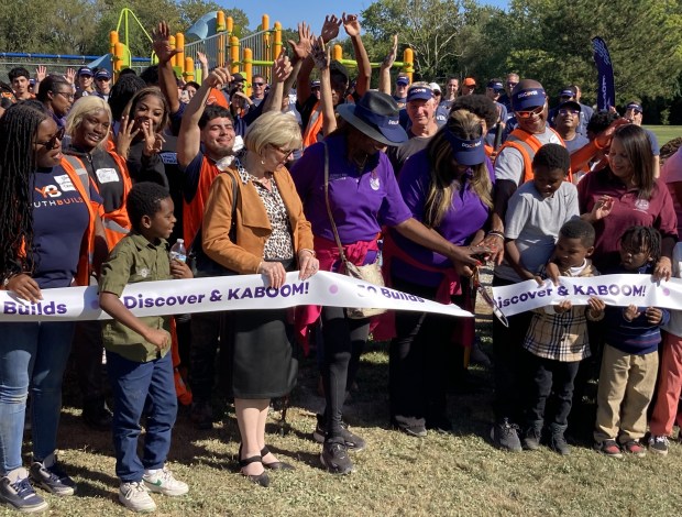 Local officials cut a ribbon after the completion of a playground build at Twin City Park. (Steve Sadin/For the Lake County News-Sun)