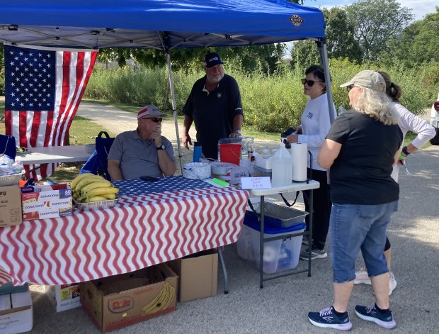 Organizers of the march get ready to give the marchers refreshments when they finish. (Steve Sadin/For the Lake County News-Sun)