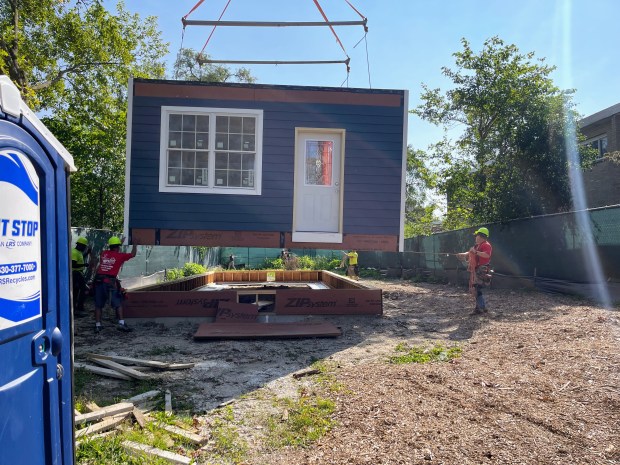 In order to move a two-story home from Evanston Township High School to 1319 McDaniel Avenue, movers had to use a truck and a crane to install the home level by level. (Richard Requena/Pioneer Press)