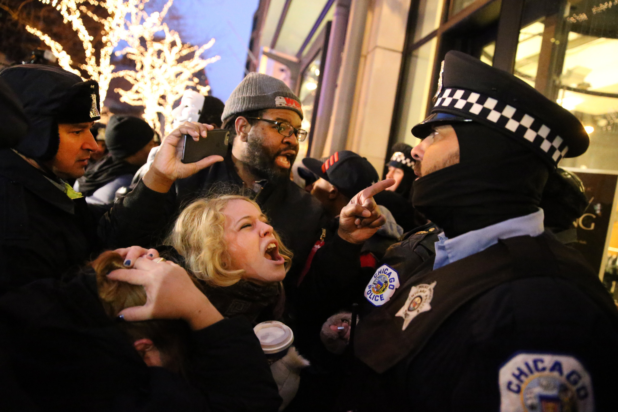 Protesters shout at a police officer on Nov. 27, 2015,...