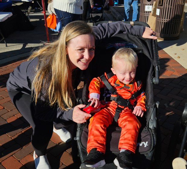 Bethanne Guidarelli of Sugar Grove and her son Arnie, who is almost 2 years old, share a moment at BatFest is Batavia on Saturday. (David Sharos / For The Beacon-News)