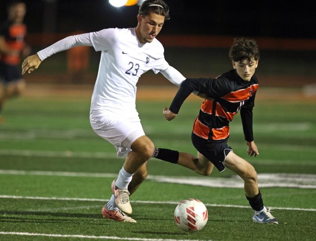 Bartlett's Nate Preissig (23) and St. Charles East's Sam Arville (11)battle for control during a non conference game in St, Charles on Wednesday, Oct. 9, 2024. (H. Rick Bamman/for the Beacon-News)