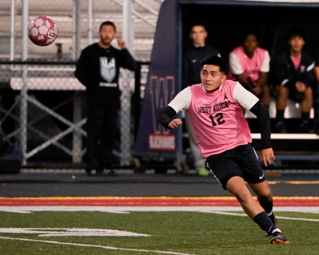 West Aurora's Pedro Delgado (12) chases down the ball against Elgin in Aurora on Tuesday, Oct. 8, 2024. (Mark Black / The Beacon-News)