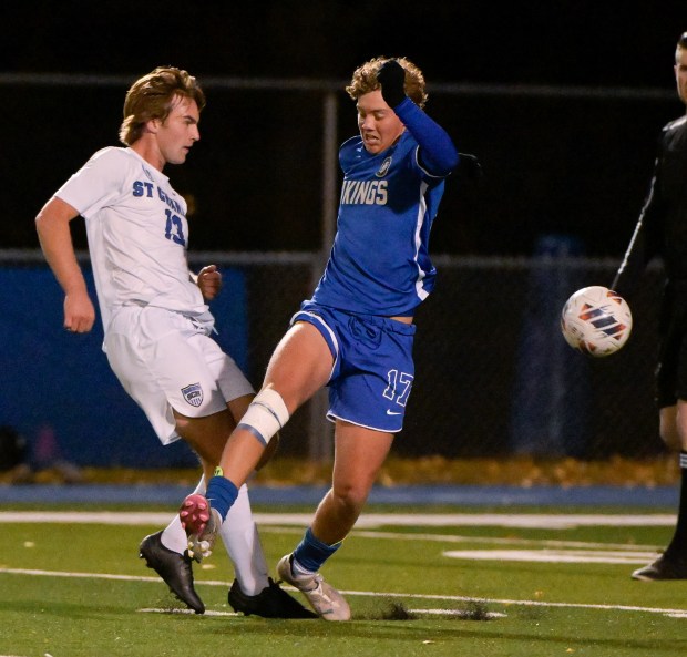 St. Charles North's Cole Weddle (13) and Geneva's Ben Murphy (17) in a match up in Geneva on Tuesday, Oct. 15, 2024. (Mark Black / for the Beacon-News)