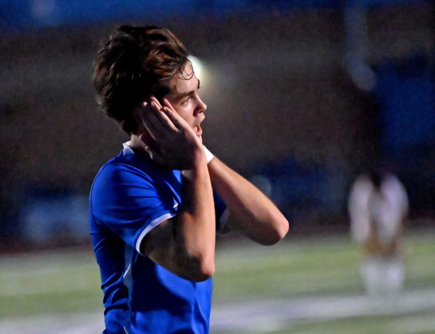 Geneva's Caleb Kelly sends a message to the fans after scoring the game-winning goal. Geneva defeated Glenbard West 4-3 in a Class 3A St. Charles North sectional semifinal boys soccer game, Tuesday, Oct. 29, 2024, in St. Charles, Illinois. (Jon Langham/for the Beacon-News)