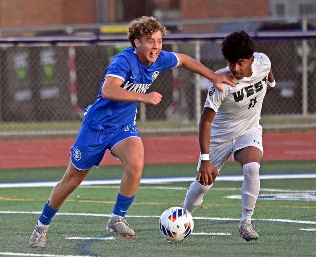 Geneva's Ben Murphy dribbles the ball past Glenbard West's Johan Palacios. Geneva defeated Glenbard West 4-3 in a Class 3A St. Charles North sectional semifinal boys soccer game, Tuesday, Oct. 29, 2024, in St. Charles, Illinois. (Jon Langham/for the Beacon-News)