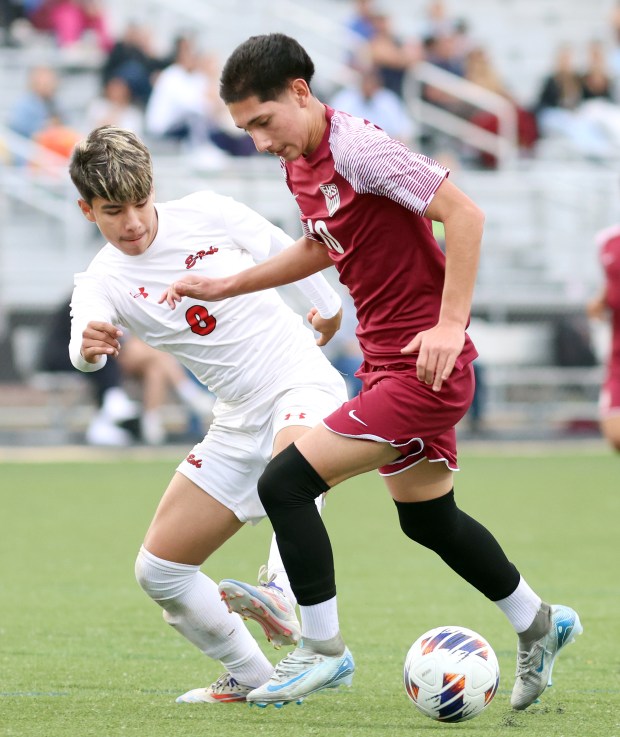 Elgin's Danny Perez, right, moves the ball near the goal as Rockford East's Omar Medina defends during the 3A Streamwood Sectional semifinals soccer game in Streamwood on Wednesday, Oct. 30, 2024.(James C. Svehla / for the Beacon-News)