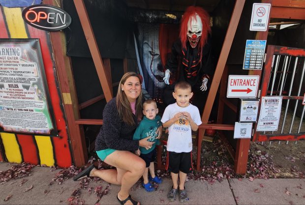 Jenna Caricheo of Elburn and her two sons Bryson 3, and Tyler, 5, visit the circus-themed haunted house on the 1100 block of Liberty Drive in Elburn, which she said is right around the corner from her home. (David Sharos / For The Beacon-News)