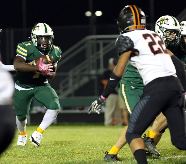 Waubonsie Valley's Chrisjan Simmons runs the ball against Dekalb during a game in Aurora on Friday, Oct. 11, 2024. (James C. Svehla / for the Beacon-News)