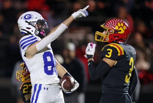 Geneva's Bennett Konkey (80) signals a first down after being tackled by Batavia's Andrew Culotta (27) and Drew DiBiase (3) in the fourth quarter during a DuKane Conference game in Batavia on Friday, Oct. 4, 2024.(H. Rick Bamman / The Beacon-News)