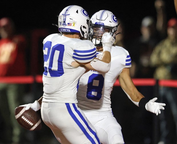 Geneva's Finnegan Weppner (8) and Michael Rumoro (20) celebrate Weppner's third touchdown in the fourth quarter against Batavia during a DuKane Conference game in Batavia on Friday, Oct. 4, 2024.(H. Rick Bamman / The Beacon-News)